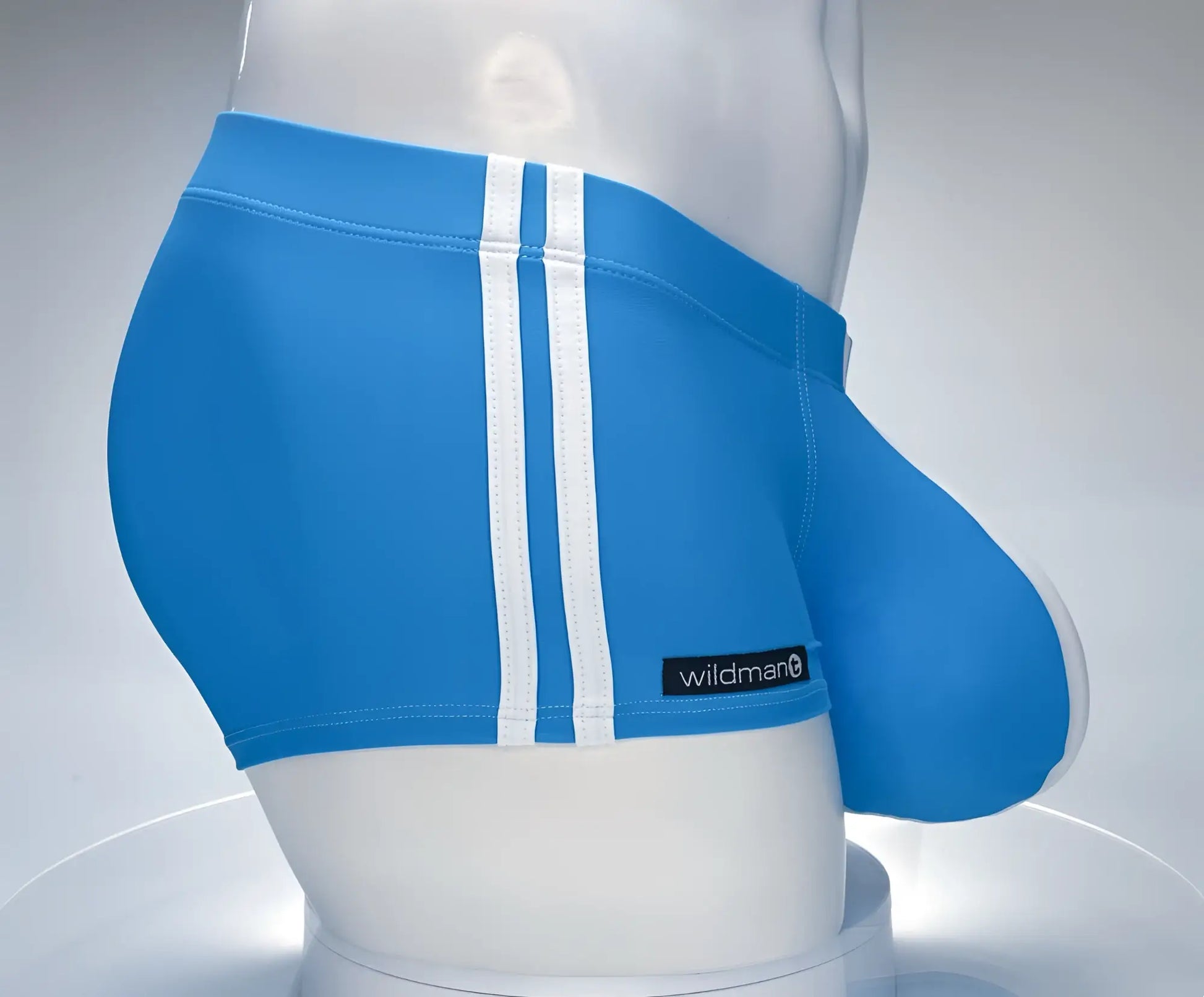 Bright blue WildmanT Monster Cock swim trunks with white vertical stripes and black wildman label on the side