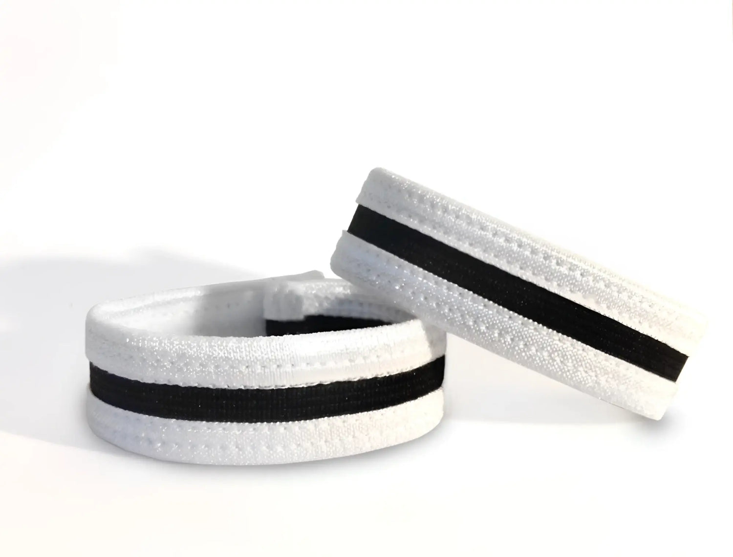 Two white and black elastic slim cock rings with stitched detailing, set against a plain white background.