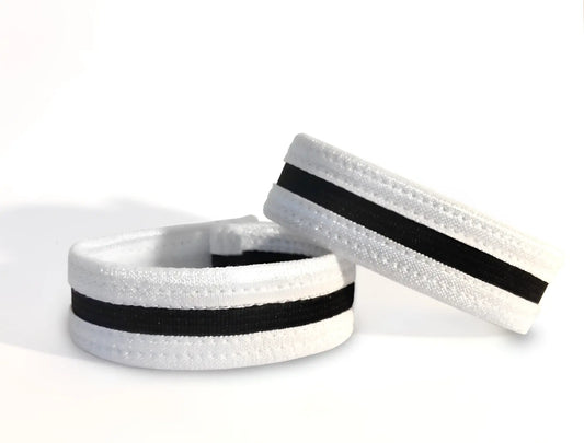 Two white and black elastic slim cock rings with stitched detailing, set against a plain white background.
