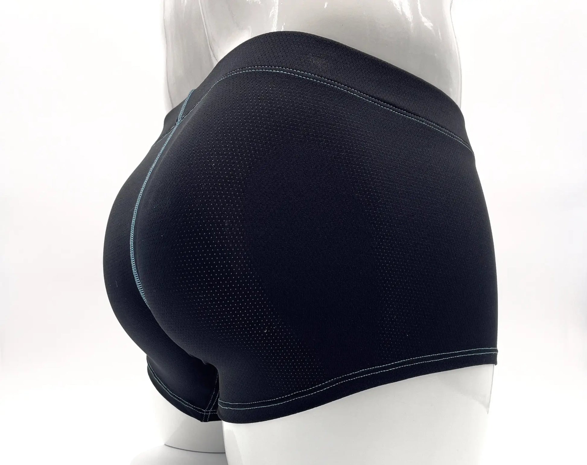 Black mesh boxer briefs with blue contrast stitching on a mannequin, shown from a rear perspective.