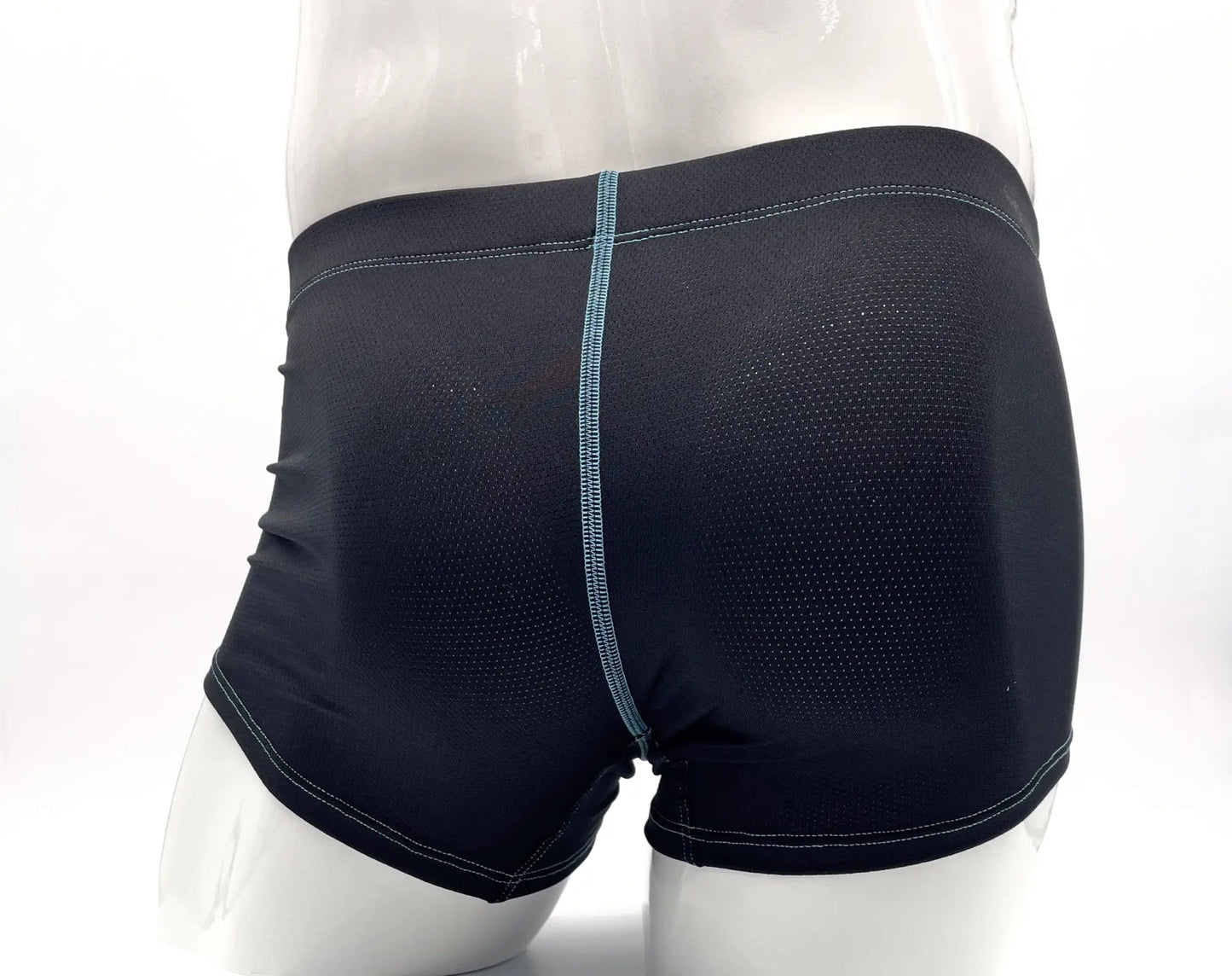 Dark blue, perforated fabric boxer briefs on a mannequin with contrasting light blue stitching detail.