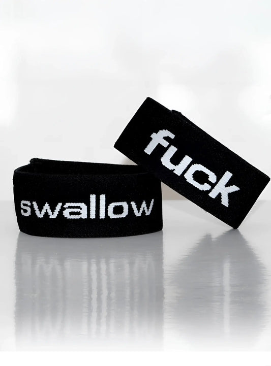 Black elastic wristband with white embroidered text fuck and swallow from wildmant verbal max cock ring fuck product