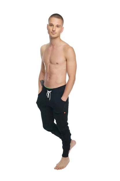 Black luxury-fleece long cuffed jogger pants with white drawstring and subtle orange logo on lower leg winter edition