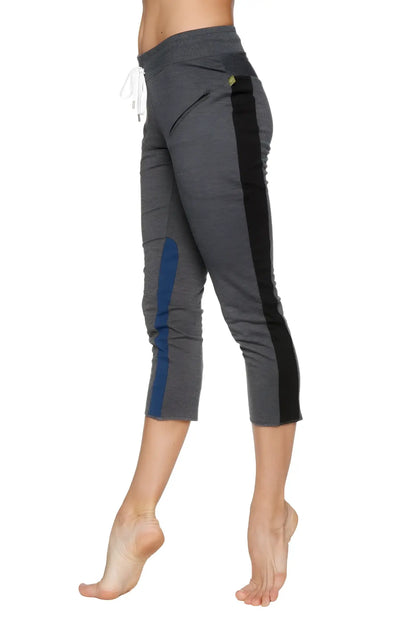 Women’s charcoal gray 4/5 length zipper pocket capri yoga pant with black and blue side panels and drawstring waistband