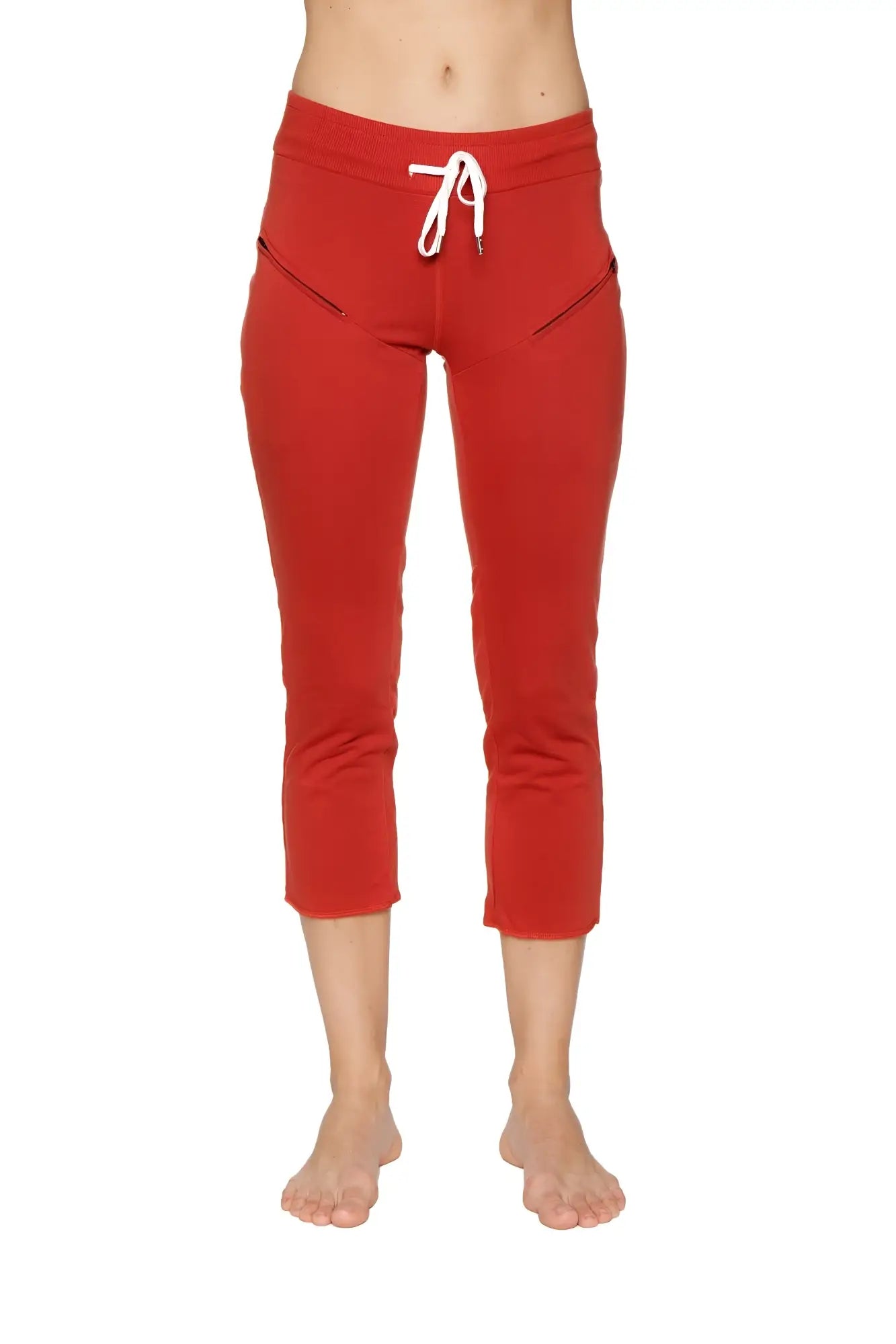 Women’s cinnabar red cropped jogger pants with white drawstring waistband and diagonal zipper pockets for yoga