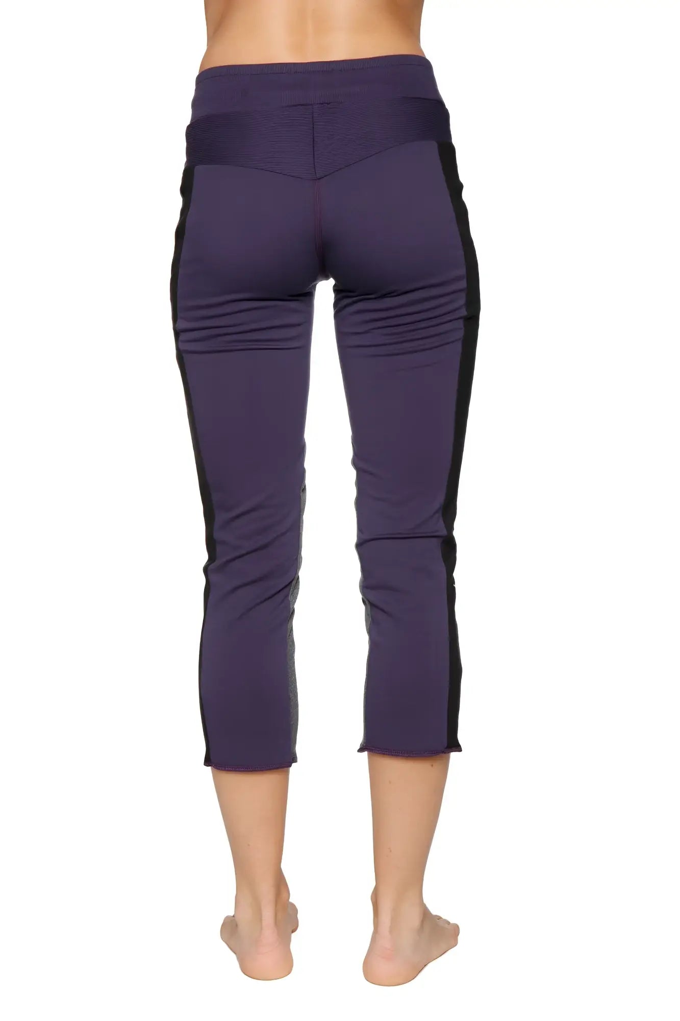 Women’s 4/5 length zipper pocket capri yoga pant in eggplant with black side panels and high-waisted elastic waistband
