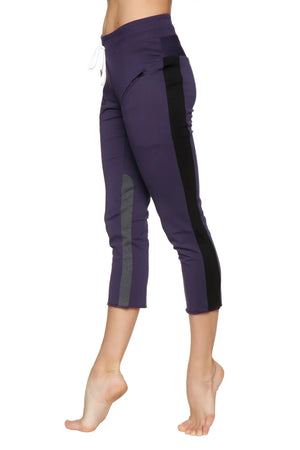 Women’s eggplant capri yoga pants with black and charcoal side panels and a white drawstring waistband.