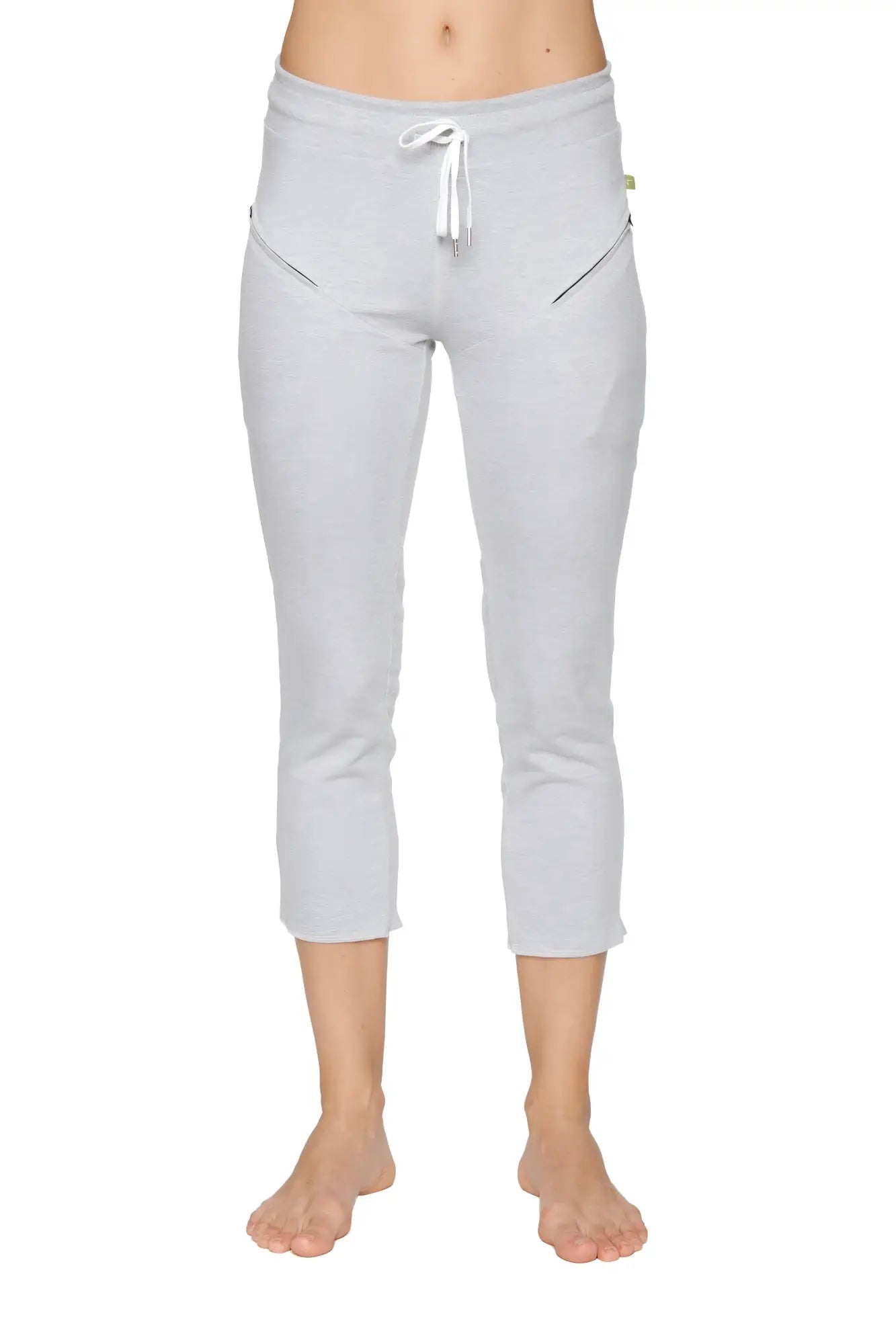 Light gray women’s 4/5 length capri yoga pants with white drawstring waistband and diagonal zipper pockets