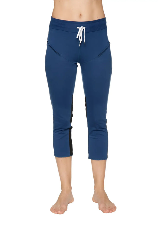 Women’s royal blue capri yoga pants with black side panels and white drawstring waistband featuring zipper pockets