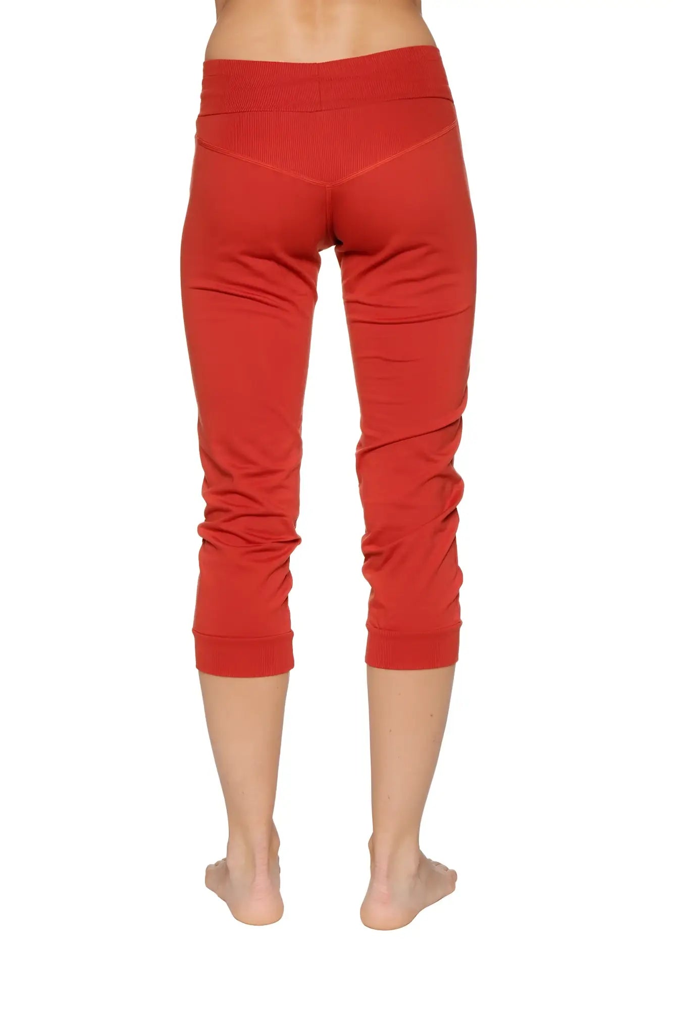 Women’s cinnabar red cuffed jogger yoga pants with stretchy form-fitting fabric and subtle ruching at lower legs