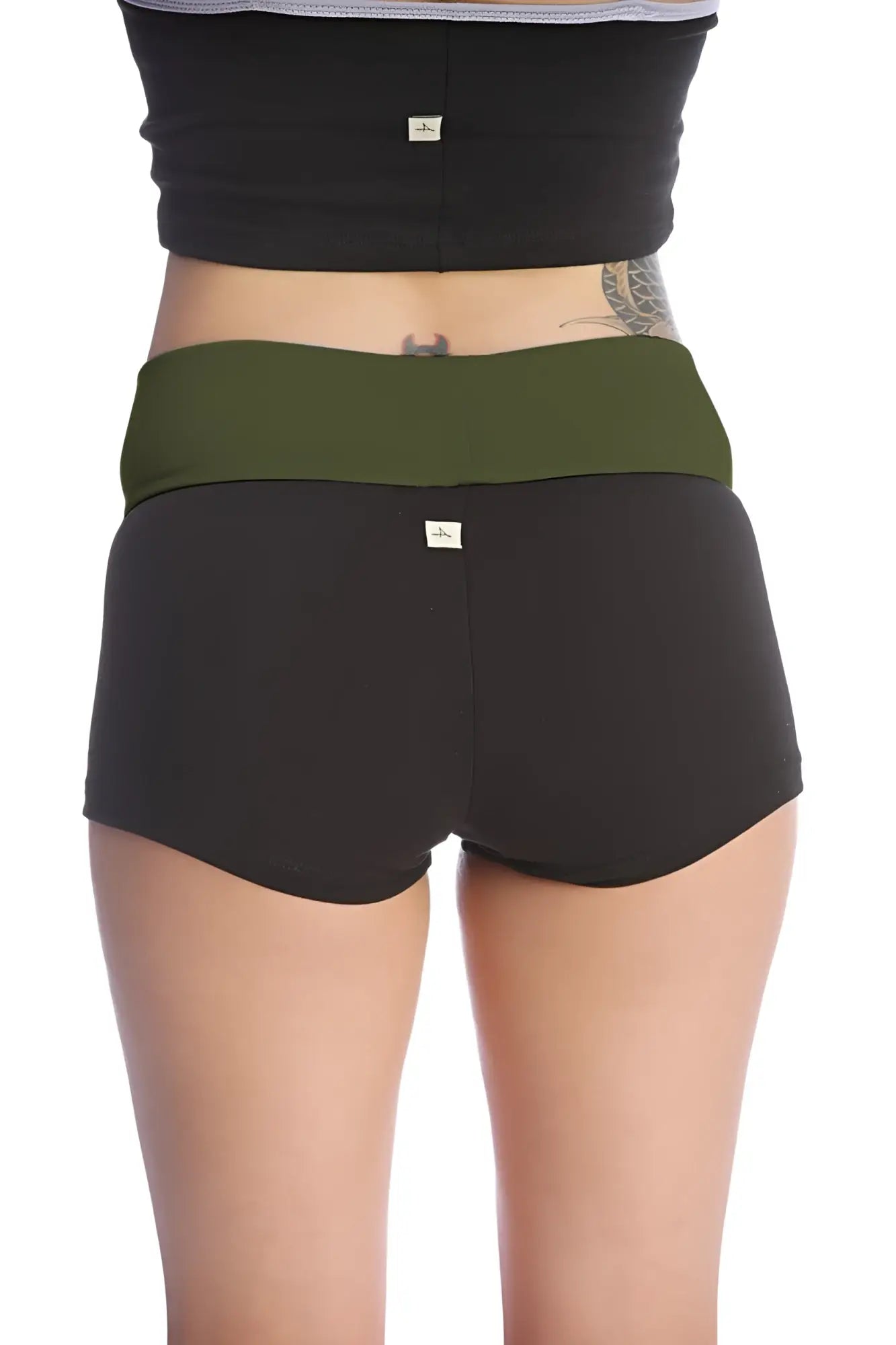 Womens yoga transition short in black with olive green waistband made of soft stretchy fabric with subtle brand tags