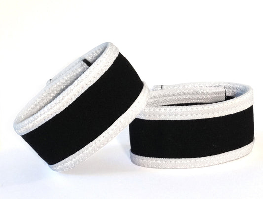 Two WildmanT Max rings in black fabric with prominent white trim, set against a plain white background.