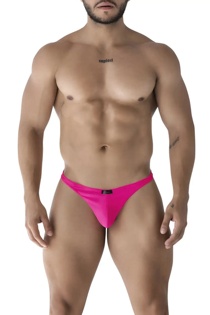 Bright pink xtremen 91232 microfiber thong with smooth fabric and small black brand tag at the waistband back side