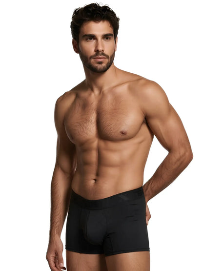 Xtremen black boxer briefs with a subtle hexagonal pattern and branded waistband on a muscular man.