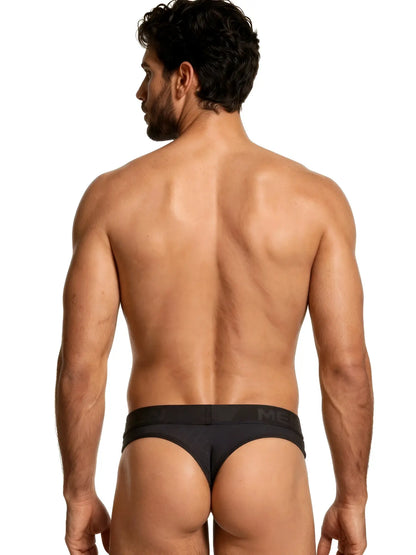 Xtremen black thong for men with a branded elastic waistband, featuring a fitted, textured fabric design.