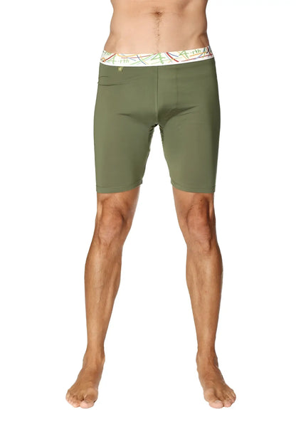 Olive green yoga compression shorts with white waistband and colorful abstract patterns for active wear