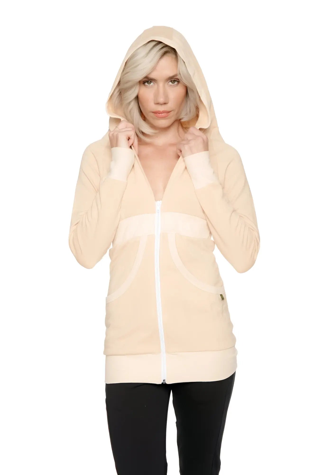 Cream-colored zip-up long body travel hoodie jacket with white trim along zipper cuffs and hem in sand beige