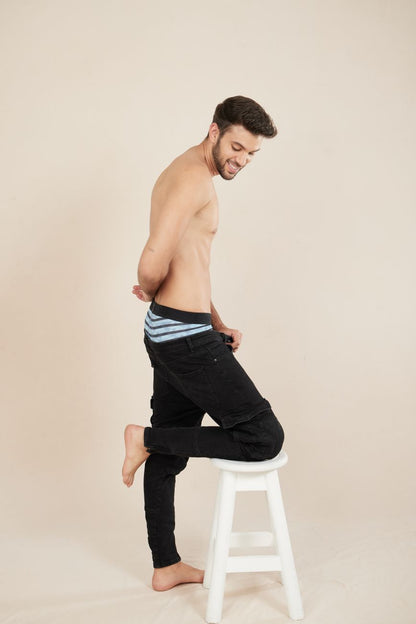 Black denim Unico Espectaculo trunks with turquoise striped waistband showing front side details