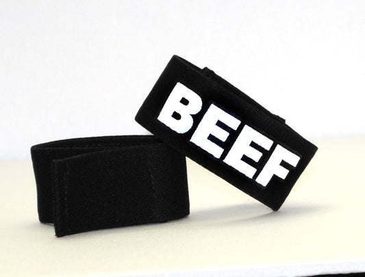 Black fabric wristband with bold white beef lettering for WildmanT Fetish Max Cock-Ring beef product