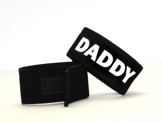 Black velour wristband with bold white daddy lettering from wildmant fetish max cock ring daddy collection