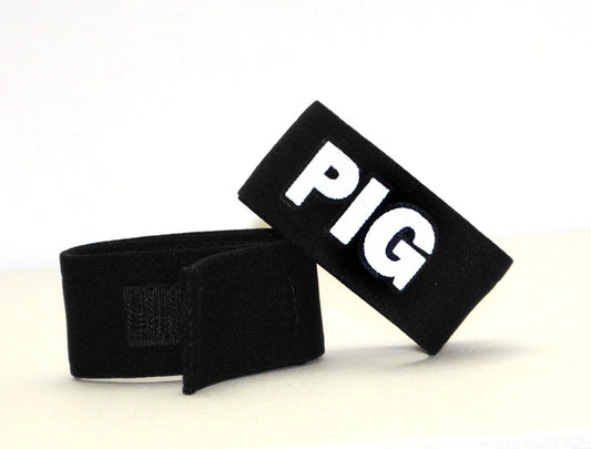 Black fabric wristband with white embroidered pig lettering part of wildmant fetish max cock-ring-pig accessory