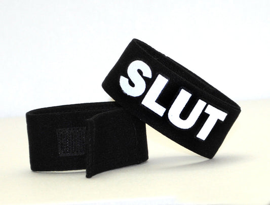 Black velour wristband with bold white embroidered slut lettering and velcro closure from WildmanT Fetish Max Cock-Ring-Slut